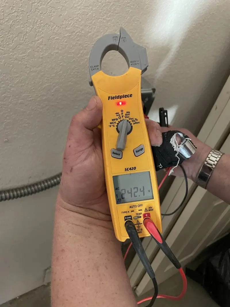 Voltage testing with clamp meter during Recessed Lighting Installation in Rocky River